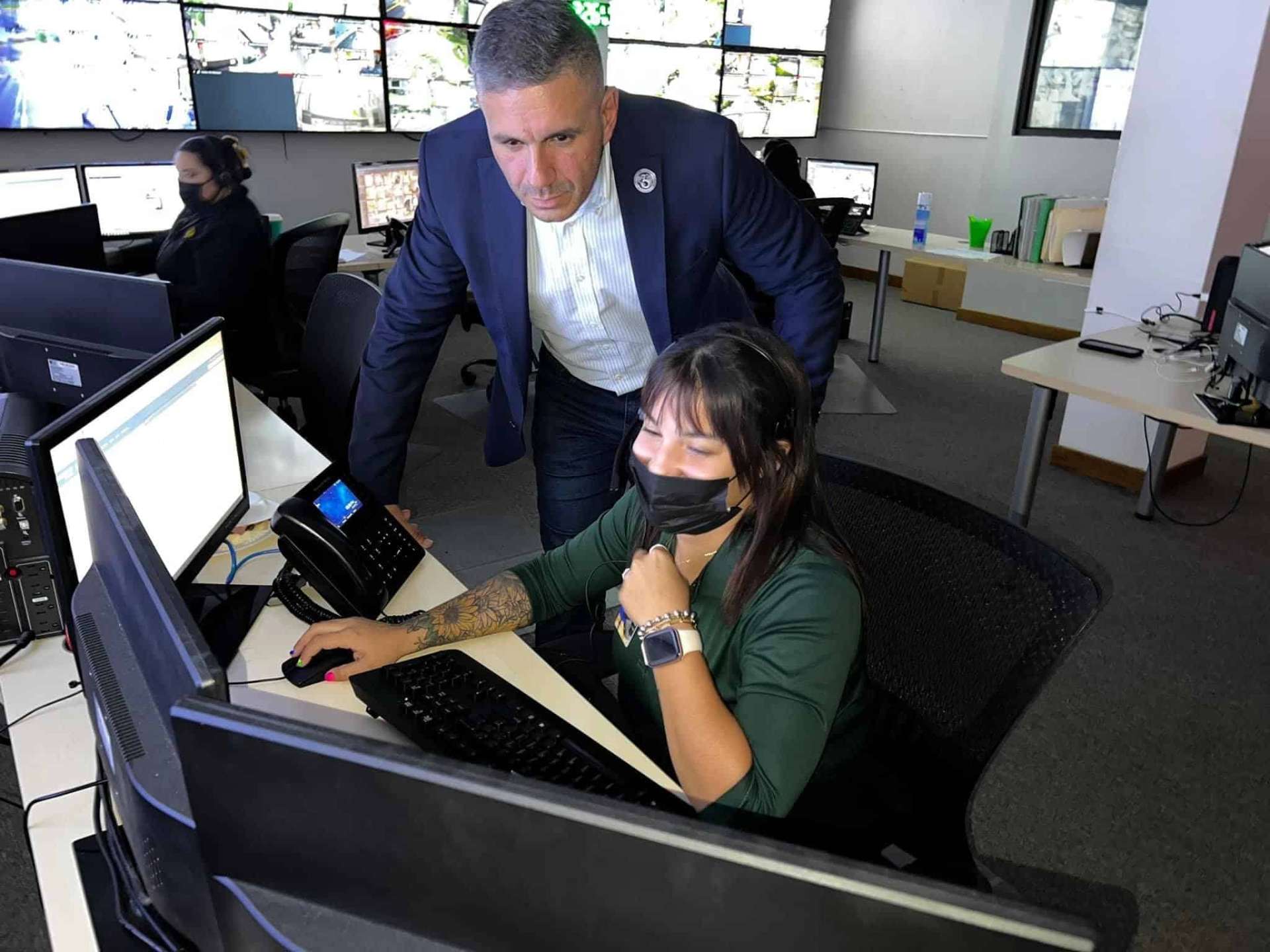 Supervisor reviewing live camera feeds with a monitoring operator