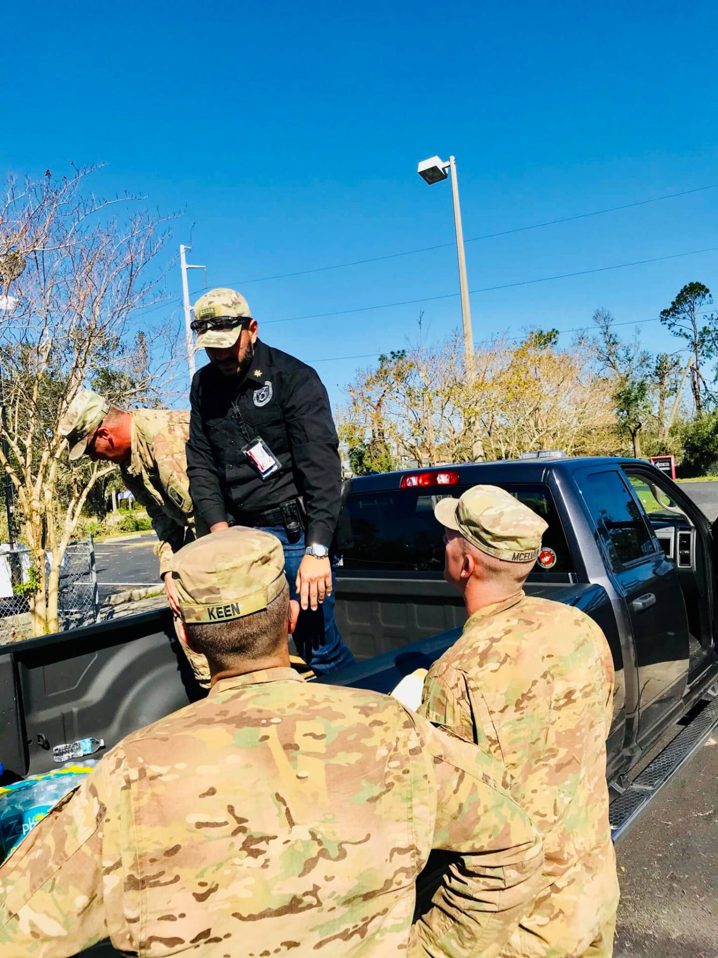 365 SMG supervisor coordinating with National Guard personnel at a staging area